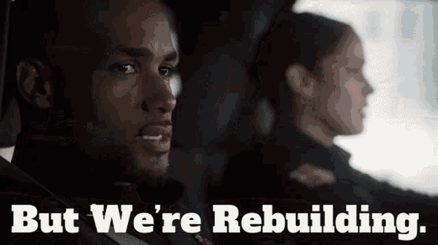 a man and a woman in a car with the words but we 're rebuilding below them