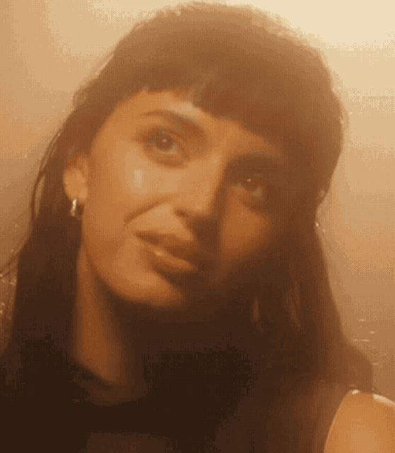 a close up of a woman 's face with dark hair