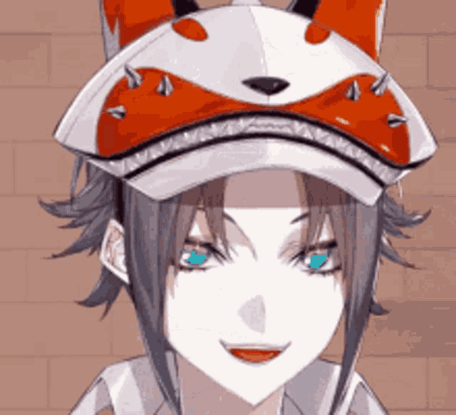 a girl with blue eyes is wearing a red and white hat with spikes on it .