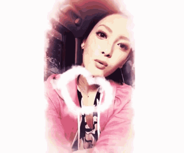 a woman wearing a pink jacket and a black and white shirt