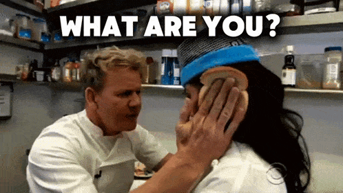 a man is putting a piece of bread on a woman 's ear and the words what are you are above him