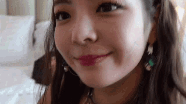 a close up of a woman 's face with a smile on it .