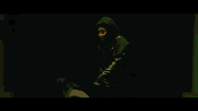 a man with dreadlocks is holding a rifle in a dark room