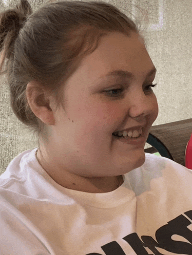 a girl wearing a white t-shirt with the word just on it