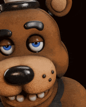 a close up of the face of a brown teddy bear with blue eyes
