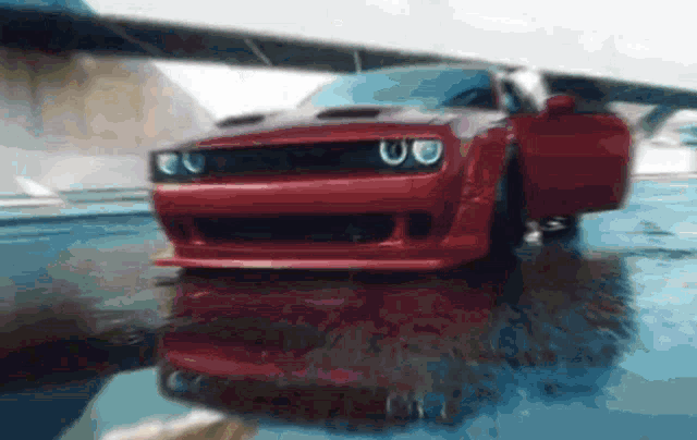 a red dodge challenger with its door open