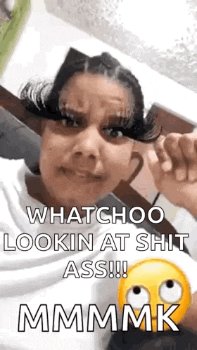 a woman with long eyelashes is making a funny face while looking at the camera .