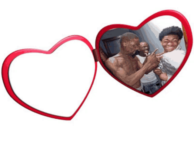 a heart shaped mirror with a picture of two men