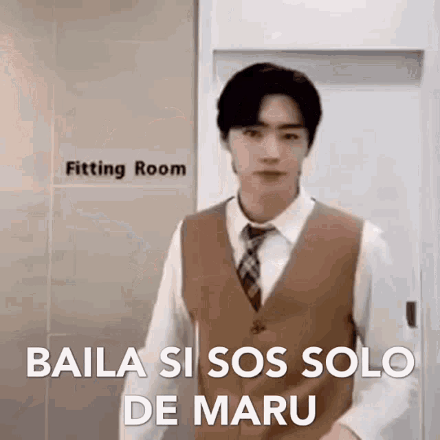 a man in a suit and tie is standing in front of a door .