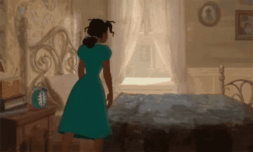 a girl in a green dress is standing next to a bed in a bedroom .