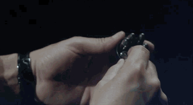 a close up of a person 's hand holding a bullet
