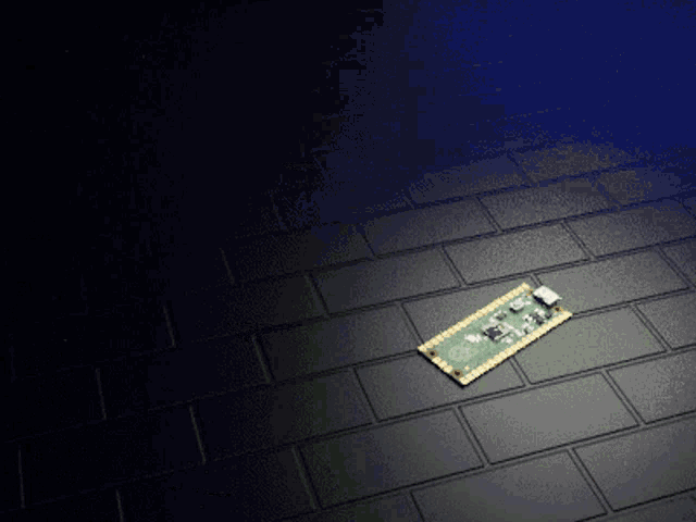 a motherboard is laying on a brick floor