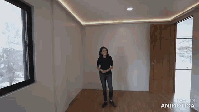 a woman is standing in an empty room with the words made in animotica on the bottom