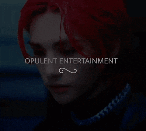 a close up of a person 's face with the words opulent entertainment on the bottom