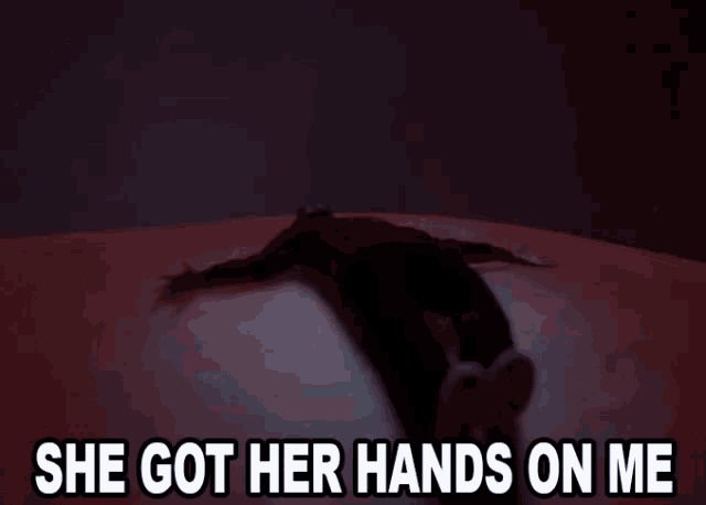a man is laying on the ground with the words she got her hands on me