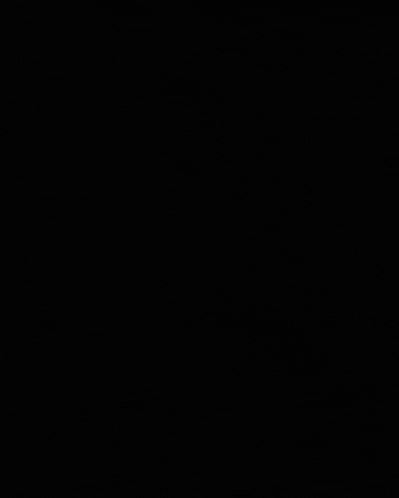 a man wearing glasses and a blue shirt is standing in a dark room