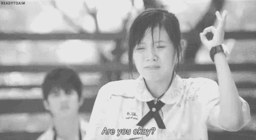 a girl in a school uniform is crying and asking are you okay