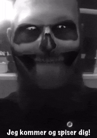 a black and white photo of a man with a skull on his face