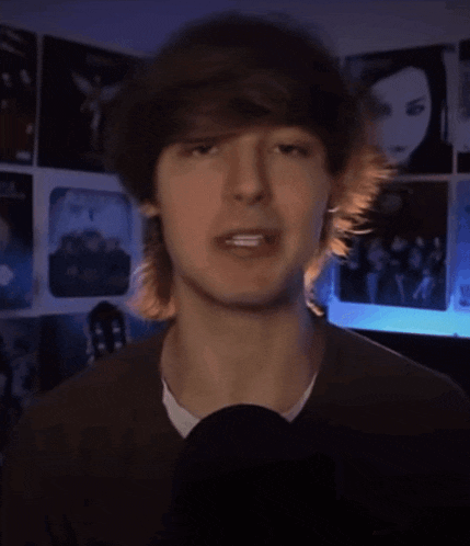 a close up of a person 's face with a microphone in front of him