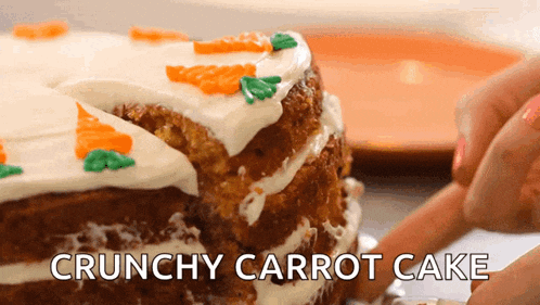 a crunchy carrot cake with white frosting and carrots on it