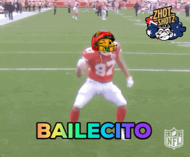 a football player with the number 87 on his jersey is dancing on a field