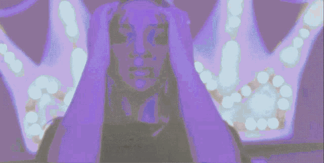 a woman is standing in front of a purple background