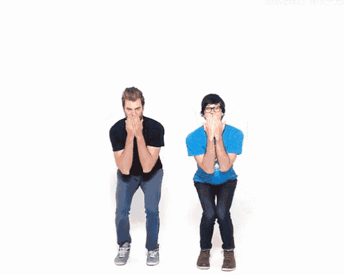 two men are jumping in the air with their hands in the air .