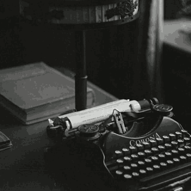 a black and white photo of a corona typewriter on a table