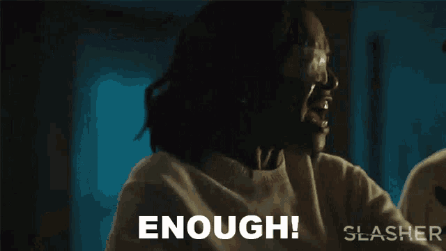 a woman is screaming and saying `` enough '' while wearing glasses .