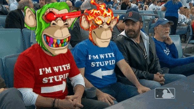 a man wearing a red shirt that says " i 'm with stupid "
