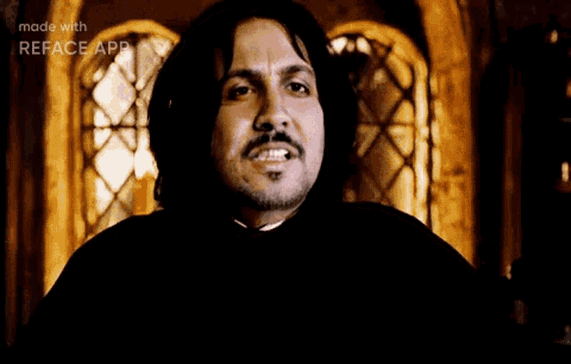 a man with long hair and a mustache is saying silence