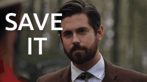 a man with a beard is standing in front of a save it sign