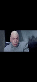a bald man is sitting in a chair with his mouth open .