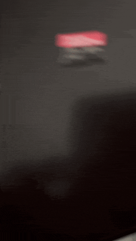 a blurred image of a black surface with a red and white stripe on it
