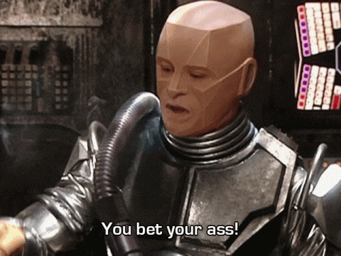 a robot says " you bet your ass " in front of a screen