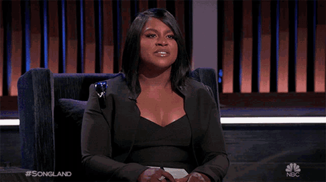 a woman sitting in a chair with the words songland on the bottom right