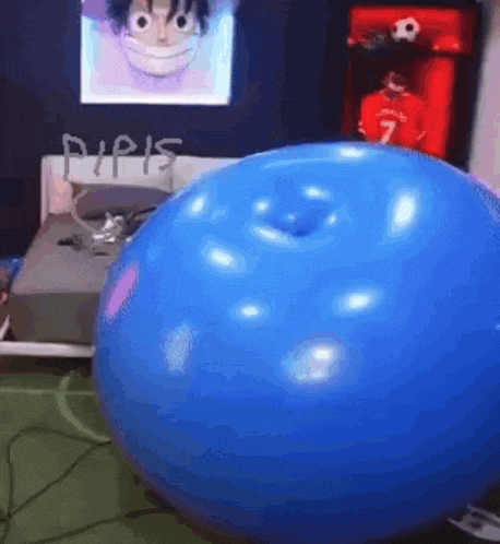 a blue balloon with a hole in it is sitting on the floor in a bedroom .