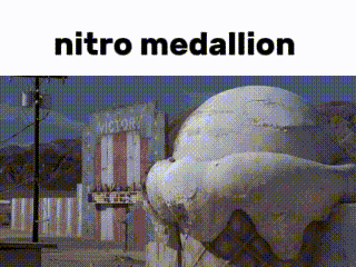 a statue of a whale is sitting in front of a building with the words `` nitro medallion '' written on it .
