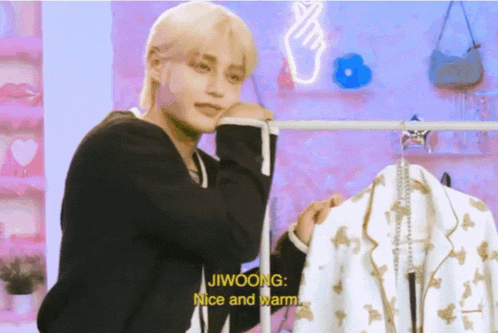 jiwoong is holding a white jacket and says nice and warm