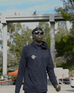 a man wearing sunglasses and a jacket that says uc san diego on it