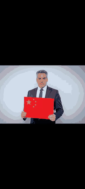a man in a suit and tie is holding a sign with a flag of china on it