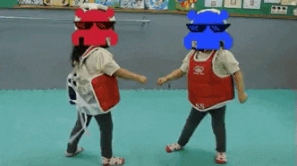 two children wearing hippo masks and sunglasses are dancing together