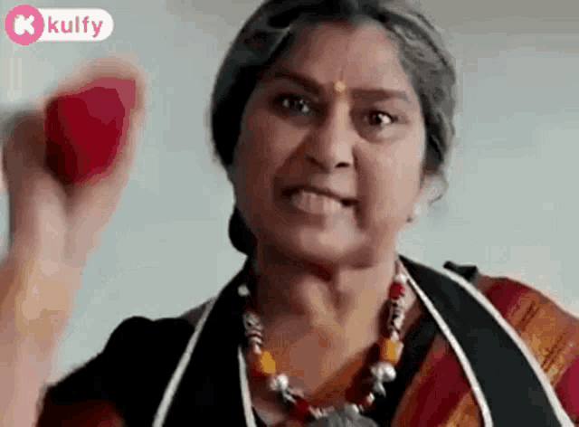 a woman is holding a red ball in her hand .