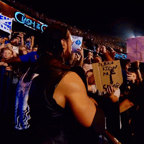 a man holding a sign that says " please sign me "