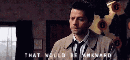 a man in a suit and tie is standing in a room with the words `` that would be awkward '' written above him .