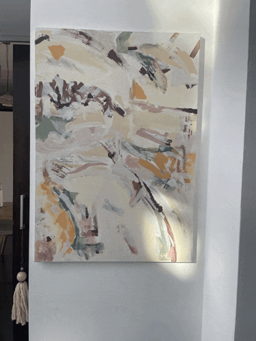 a large painting is hanging on a wall in a hallway