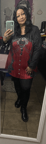 a woman takes a selfie in front of a mirror