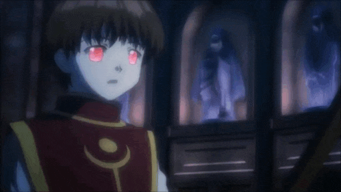 a man in a red vest is standing in a dark room with a ghost behind him .