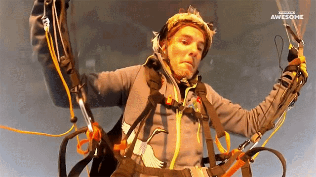 a man in a parachute with the word awesome written above him