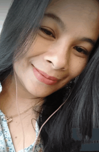 a close up of a woman 's face with long black hair